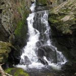 Waterfall over mossy rocks