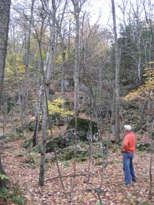 man standing among boulder field in fall 