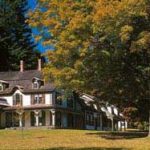 Bryant homestead in early spring with tree out front