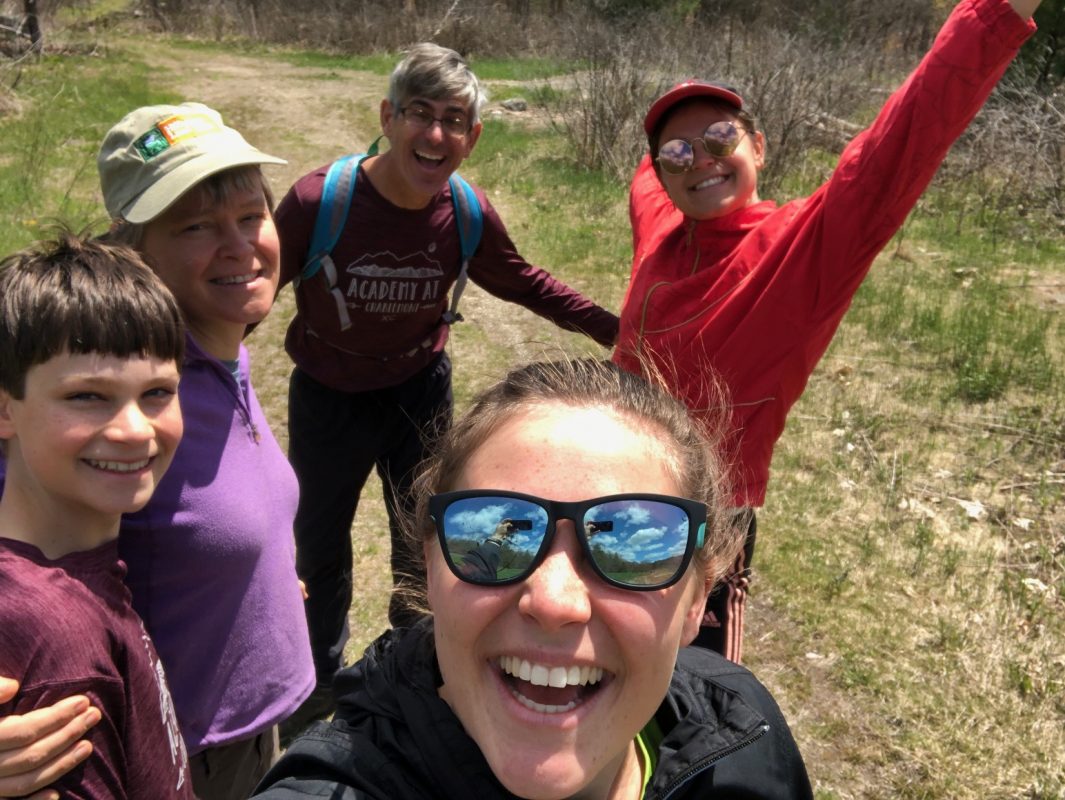 Sally Loomis, her husband, and three kids pose for a fun selfie on a hike